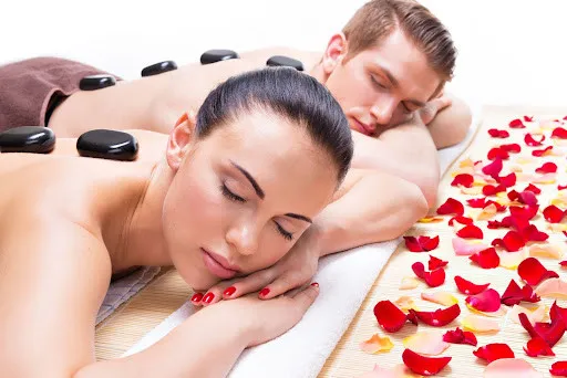 Couple enjoying side-by-side massage in NYC with Knead NYC therapists