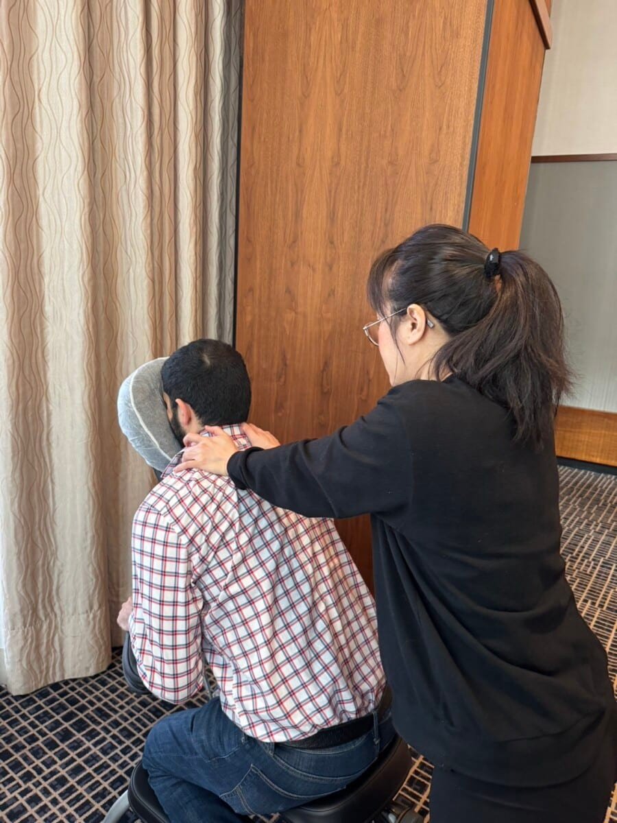 Gallery 1 On-site chair massage event in New York City workplace with employees relaxing during sessions by professional therapists