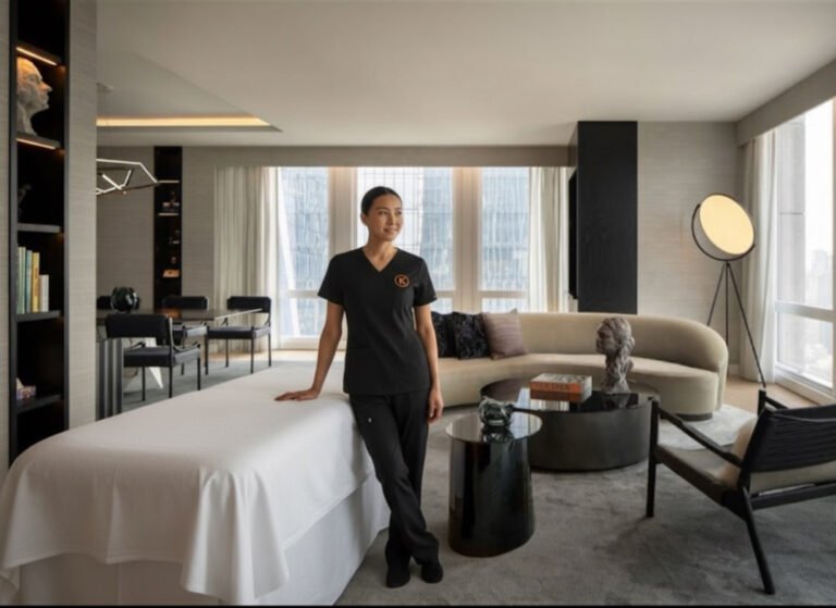 Knead NYC massage therapist setting up for luxury in-room massage at Manhattan hotel suite