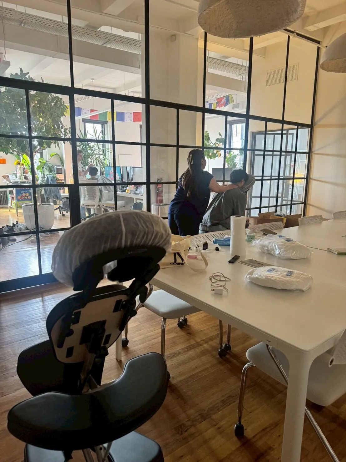Massage chair and event supplies prepared for an on-site office wellness session