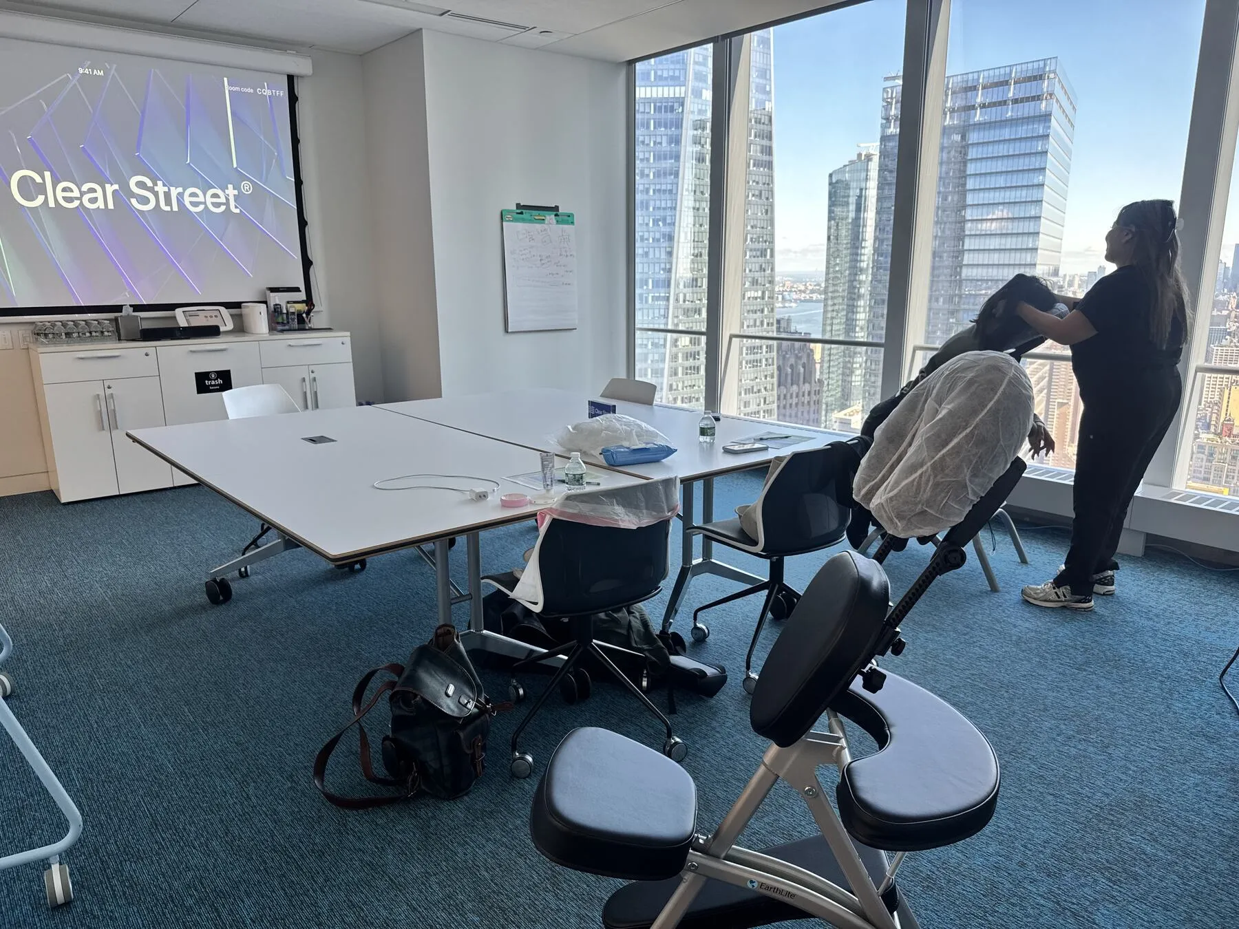 Chair massage stations set up for a Clear Street corporate wellness event