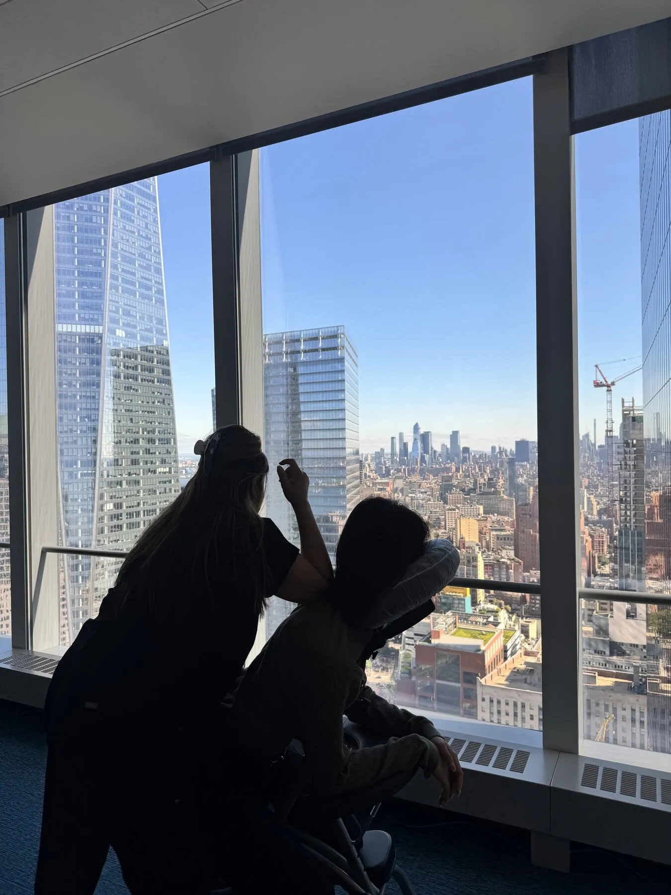 Chair massage session in a Manhattan high-rise office overlooking the city skyline