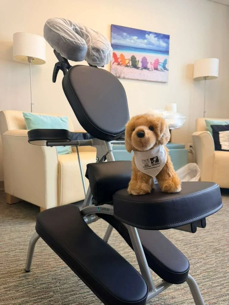 Portable massage chair featuring a small event mascot in an office lounge