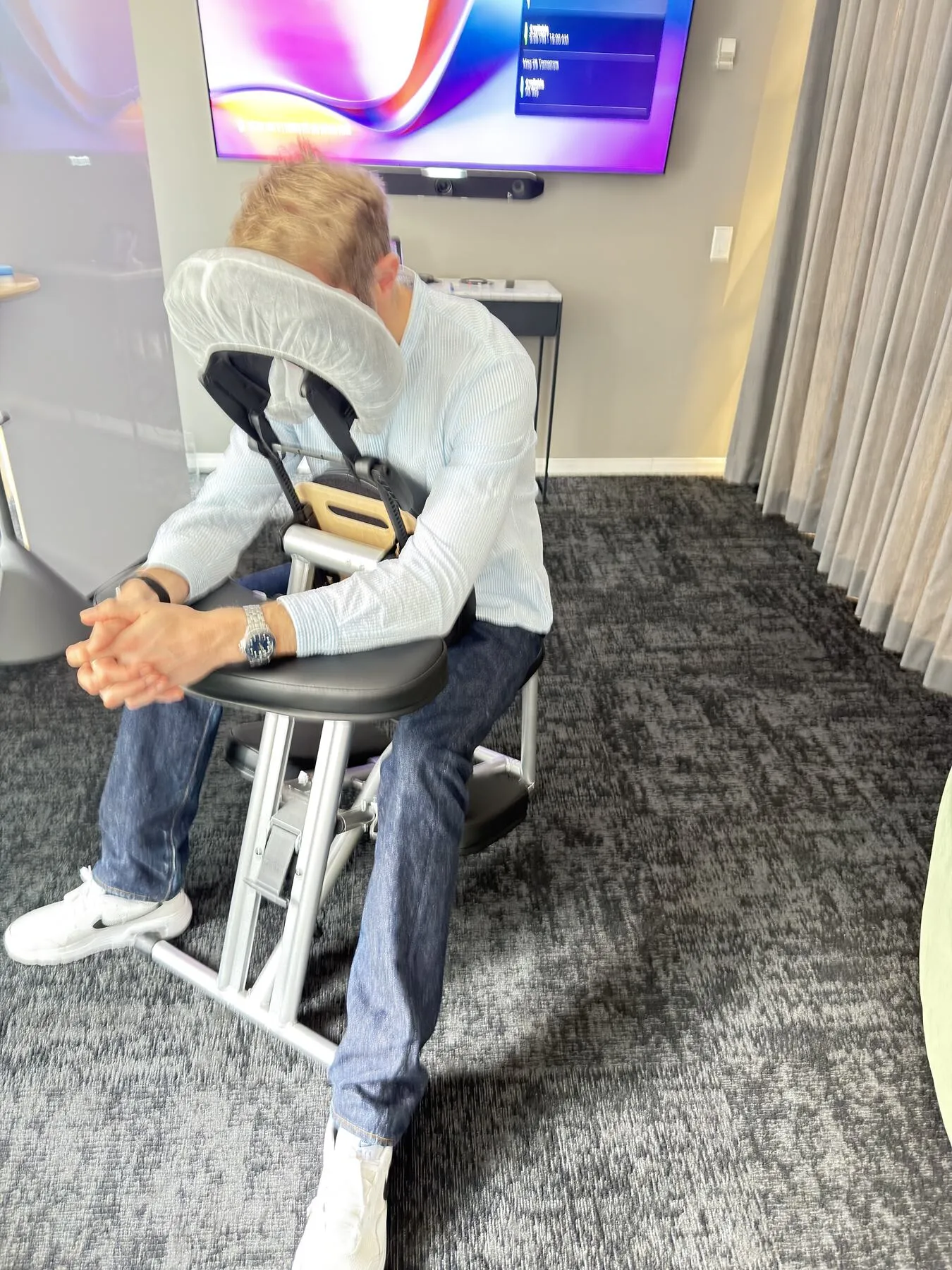 Corporate event attendee relaxing during a seated chair massage